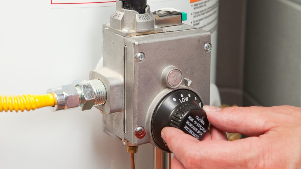 Homeowner adjusting a digital geyser timer schedule